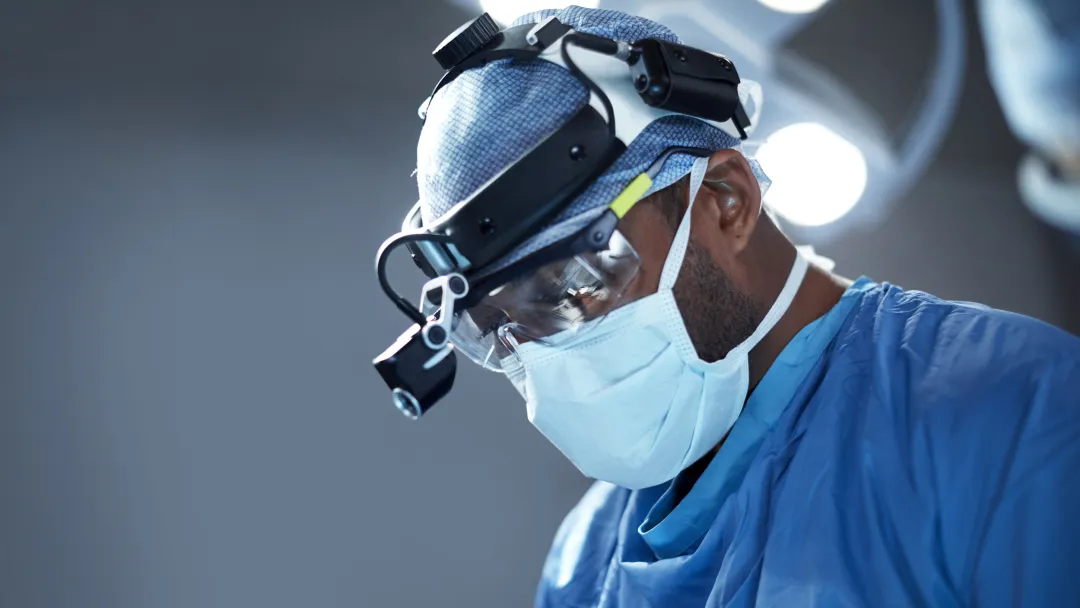 A doctor focused while doing his surgery