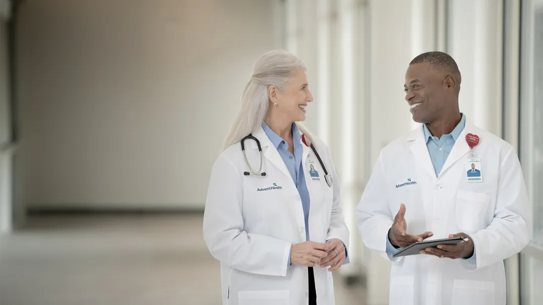 Two doctors talking in a hallway at a hospital