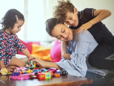 A mom playing with her kids. 