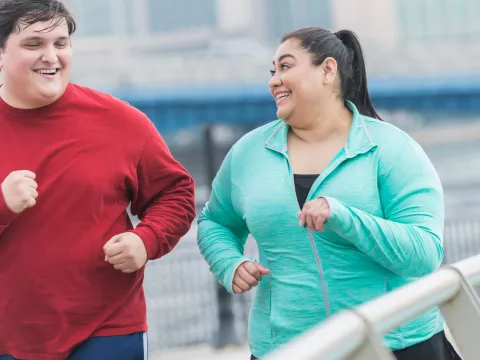 A couple goes for a jog together to improve their health.