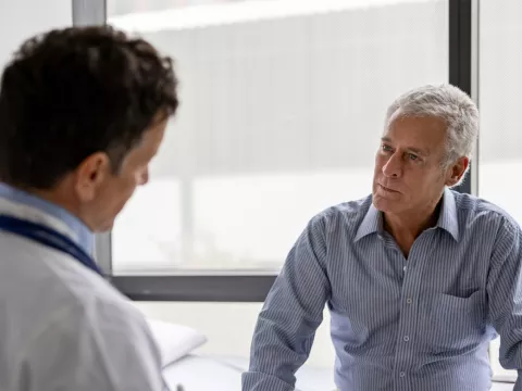 Older Man talking his doctor about Aquablation.